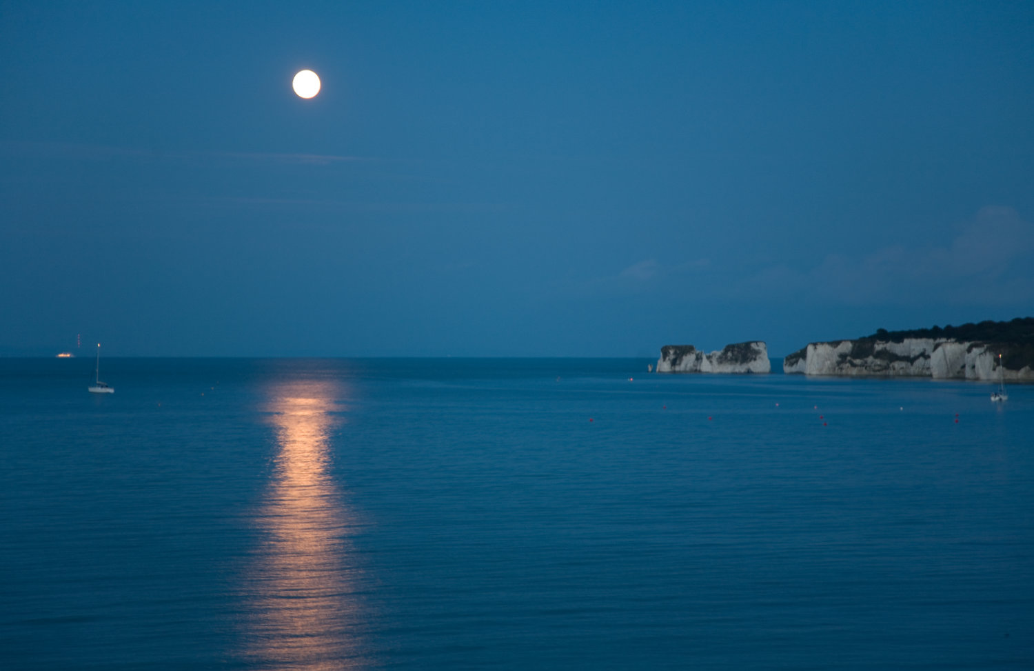 Photo of moon rising over old harry